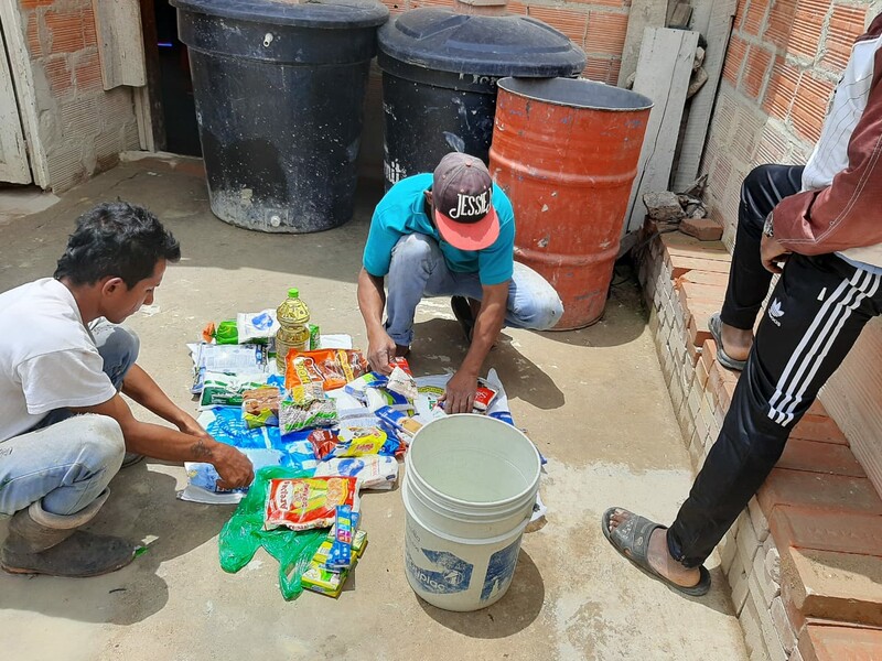 Family in a community on the outskirts of Bogota, Colombia receiving groceries